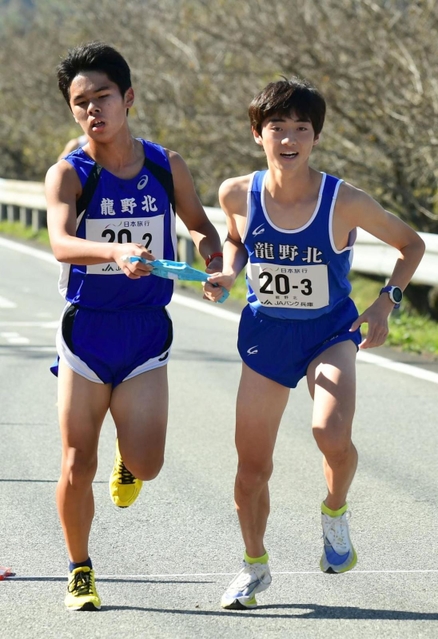 男子・龍野北の２区石田楓真選手（左）からたすきを受け取る３区東虎汰朗選手＝丹波篠山市内（撮影・坂井萌香）