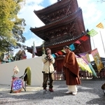 斑鳩寺の大谷康文住職（右）と並んであいさつするスズキコージさん＝太子町鵤