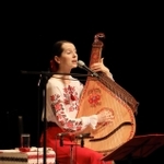 ウクライナ出身の歌手ナターシャ・グジーさんのチャリティーコンサート。民族楽器「バンドゥーラ」の弾き語りを披露した＝たつの市龍野町富永、赤とんぼ文化ホール