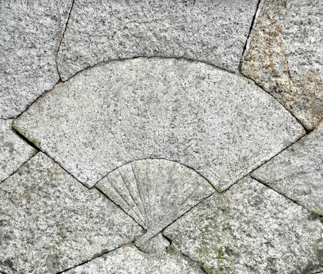 本殿石垣にある扇の飾り石＝東有年八幡神社