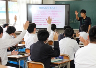 クイズを交えながら仕事について紹介する商工会青年部員の安積希真さん（右奥）＝市川町東川辺