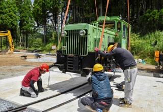クレーン車でつり上げられ、周回コースに移されるディーゼル機関車＝フォレストステーション波賀