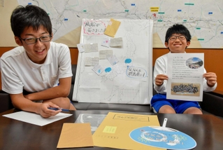 群馬から来た手紙に返信する山崎西小の上杉健太君（右）と伊野欧介君＝山崎西小学校