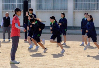 徳田さんから走りのフォームを教わる生徒＝福崎町福田