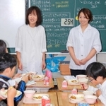 児童を前に全国学校給食甲子園での健闘を誓う水谷あゆみ栄養教諭（左）と森淑香給食員＝相生市向陽台、双葉小学校