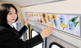 デザインした姫新線の路線図を、車両内に掲示する龍野北高校の生徒＝姫路市飾西
