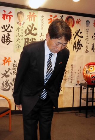 落選の報を受け、支援者らに頭を下げる田中基康氏＝２６日夜、たつの市龍野町日飼