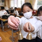 配布された「熊鈴」を手にする児童。早速、ランドセルに付けて下校した＝宍粟市山崎町鹿沢、山崎小学校