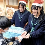 大阪・関西万博のイタリア館レストランから提供された小麦粉で作ったクッキーを配る上郡高校生ら＝赤穂市加里屋