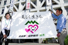 松本市が市役所正面玄関の掲揚台に掲げる「健康寿命延伸都市」の旗。ワンフレーズで独自性を打ち出す＝長野県松本市