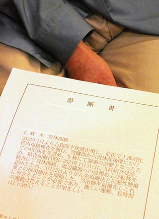 「闘病生活に入ってから、体に負担がかからないよう、好きなお酒をやめて規則正しい食生活を送っている」と診断書を示しながら話す男性＝神戸市内