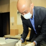 米国立公文書館で収集した資料を見せる仲本和彦さん。大量の資料の中には、沖縄返還交渉時の密約文書もあったという＝沖縄県南風原町、同県公文書館