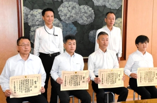 全国優良警察職員表彰を受け、村井紀之兵庫県警本部長（後列左）に報告した警察官ら＝県警本部