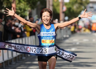 初優勝を飾り、笑顔でフィニッシュする地元・神戸市出身の堀江美里＝神戸市中央区