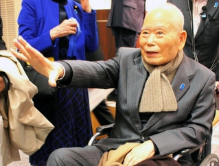 拉致被害者救出を求める集会で支援者らと話す有本明弘さん＝２６日午後、東京都千代田区