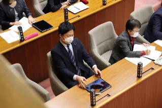 本会議に参加する光本圭佑議員（中央）。神戸地検が６日に起訴した＝６日午後、尼崎市東七松町１、尼崎市議会本会議場