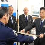 タクシーに乗り込んだ女性客が被害被害に遭うのを防ぎ、表彰される阪急タクシーの西田恵人さん（右）＝尼崎市潮江５、尼崎東署（撮影・吉田敦史）
