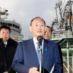 視察先で取材に応じる菅義偉前首相（中央）＝２５日午後、神戸市中央区神戸空港