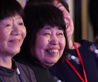 ステージを見つめる亀井秀子さん（中央）。「観客に一体感が生まれた瞬間が最高」と話す＝神戸市垂水区日向１、レバンテホール