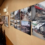 壁一面に張られた写真を前に、常連客と震災当時を振り返る陽山俊夫さん（左奥）＝神戸市東灘区御影石町２