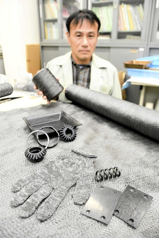新素材の「カーボンレジンクロス」と、新素材を加工して出来上がったコイル式のばねや板ばねなど＝西脇市野村町