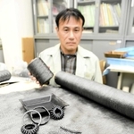 新素材の「カーボンレジンクロス」と、新素材を加工して出来上がったコイル式のばねや板ばねなど＝西脇市野村町