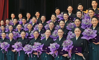 ブーケを手に顔をほころばせる卒業生たち＝１日午前、宝塚市武庫川町、宝塚音楽学校（撮影・吉田敦史）