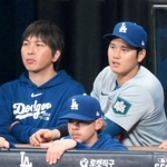 ベンチでパドレスの攻撃を見つめるドジャース・大谷翔平（中央右）と水原一平氏（同左）＝２０日、韓国・高尺スカイドーム