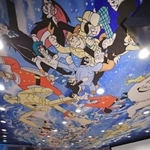 手塚作品のキャラクターが天井を彩る映像ホールで開かれたセレモニー＝２５日午前、宝塚市武庫川町、手塚治虫記念館（撮影・吉田敦史）