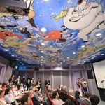 手塚作品のキャラクターが天井を彩る映像ホールで開かれたセレモニー＝２５日午前、宝塚市武庫川町、手塚治虫記念館（撮影・吉田敦史）