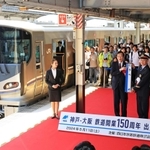 記念列車のそばで、駅名標を手に記念撮影する神戸市の久元喜造市長ら＝１１日午前、同市中央区相生町３、ＪＲ神戸駅（撮影・小林良多）
