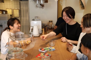 客と談笑する高井萌さん（左）＝尼崎市上坂部３