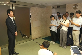 登庁時に報道陣の取材に応じる斎藤元彦知事（左端）＝30日午前、兵庫県庁