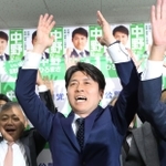 万歳をして当選を喜ぶ中野洋昌氏＝尼崎市昭和南通７（撮影・笠原次郎）