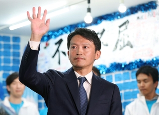当選の知らせを受けて支持者らに手を振る斎藤元彦氏＝１７日午後、神戸市中央区