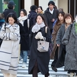 マフラーやコートなどで防寒対策をして出勤する人たち＝１０日午前、神戸市中央区、ＪＲ元町駅前（撮影・笠原次郎）