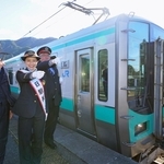 加古川線の全線開業１００周年を祝う谷川駅の一日駅長を務めた斉藤雪乃さん（中央）ら＝２７日午後、ＪＲ谷川駅