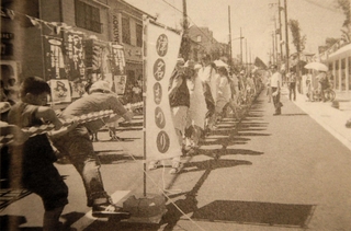 まちの復興を願って企画された志筑地区の綱引き大会。真新しい道路で、６００人が綱を引いた＝２０００年８月（「広報つな」から）