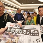 長嶋茂雄さんの死去を伝える神戸新聞号外を受け取る人ら＝３日午前、神戸市中央区、デュオこうべ（撮影・長嶺麻子）