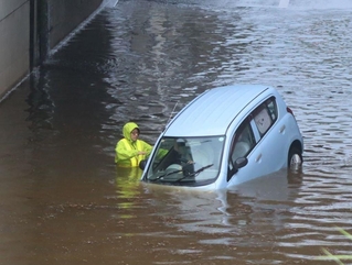 アンダーパスで冠水した乗用車。運転手はその後すぐに救出された＝８日午後３時４７分、三田市川除