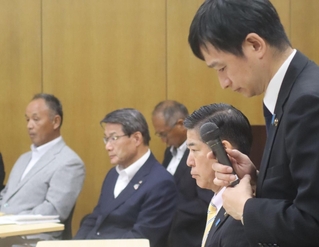 農業関係者との面会で、上越市の中川幹太市長（手前）の説明を厳しい表情で聞く出席者＝29日午前、三田市川除、市総合福祉保健センター