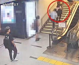 被害者の女性（赤丸）の後を歩く谷本将志容疑者とみられる男の画像＝２０日午後７時３分ごろ（神戸市内の防犯カメラ映像より、画像の一部を加工しています）