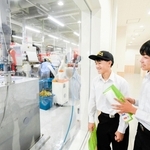 バイオマス発電などに取り組む企業の工場を見学する浜脇中学校の生徒＝岡山県真庭市勝山（提供）