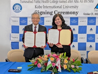 協定書を手にする神戸国際大学の下田繁則学長（左）と「ユヌスバッド公衆衛生テフニクム」のヌルマトワ・ニゴラ・アトハンベコヴナ学長＝神戸市東灘区向洋町中９