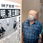 公明党の連立政権からの離脱方針を伝える号外を見る人たち＝１０日午後、神戸市中央区、デュオこうべ（撮影・中西幸大）