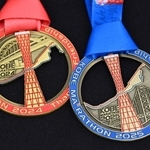 神戸マラソンの完走者メダル。右が２０２５年で左が２４年のもの