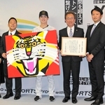 賞状と記念品のアクリル画を受け取った中野拓夢選手（左から３人目）と粟井一夫球団社長（同４人目）＝２５日午前、兵庫県庁