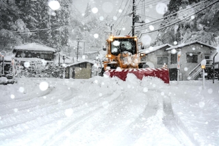 道路に雪が降り積もり、除雪車による作業が続いた＝２６日午前、養父市葛畑（撮影・吉田みなみ）