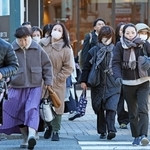  マフラーやコートなどで防寒対策をして出勤する人たち＝２６日午前、神戸市中央区、ＪＲ元町駅前（撮影・丸山桃奈）