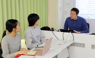 「３０年限界説」をテーマに研究する学生に声をかける金菱清教授（右）＝西宮市上ケ原一番町、関西学院大